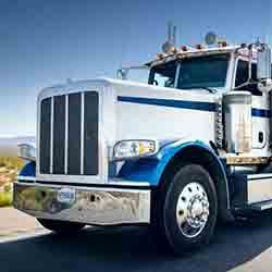 White and Blue Semi Truck on highway